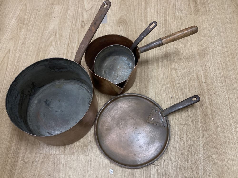 Three 19th century copper pans, one with lid, middle saucepan 27cm diameter
